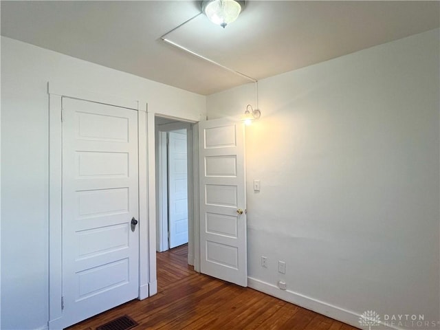 spare room featuring dark hardwood / wood-style floors