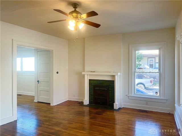 unfurnished living room featuring dark hardwood / wood-style floors and ceiling fan