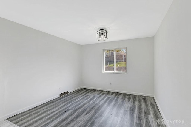 unfurnished room with hardwood / wood-style floors