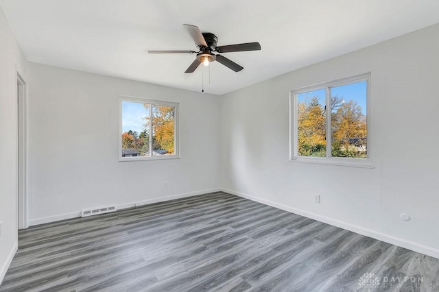 6168 Cantata Ct, Dayton, OH 45449 - unfurnished room featuring baseboards, visible vents, wood finished floors, and plenty of natural light