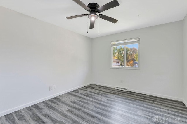 empty room featuring hardwood / wood-style floors and ceiling fan