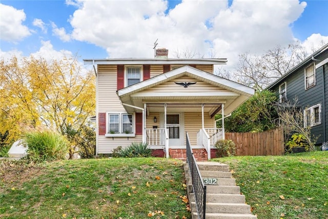 view of front facade with a front lawn and a porch