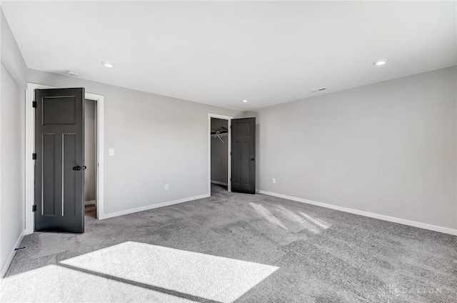 unfurnished bedroom with carpet floors, baseboards, recessed lighting, a spacious closet, and a closet