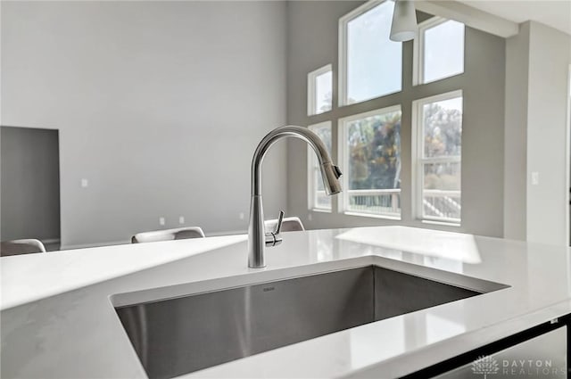 kitchen view of a sink and light countertops