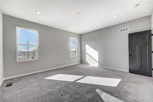 carpeted empty room with a smoke detector, baseboards, and recessed lighting