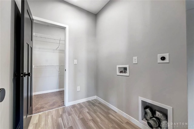 washroom featuring electric dryer hookup, washer hookup, baseboards, and light wood-type flooring