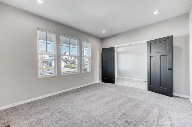 unfurnished bedroom featuring carpet floors, baseboards, and recessed lighting
