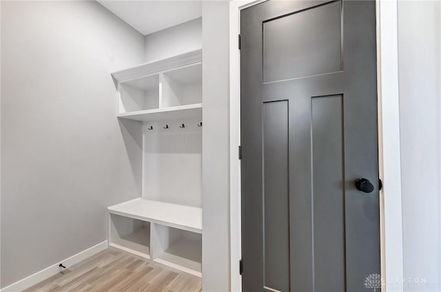 mudroom featuring light wood-style floors and baseboards