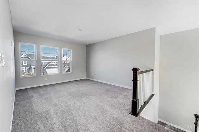 spare room with carpet and baseboards