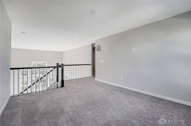 carpeted empty room with baseboards