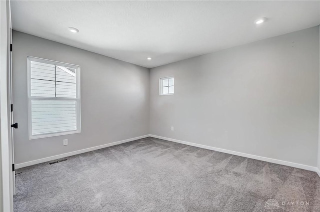 carpeted spare room with baseboards and recessed lighting