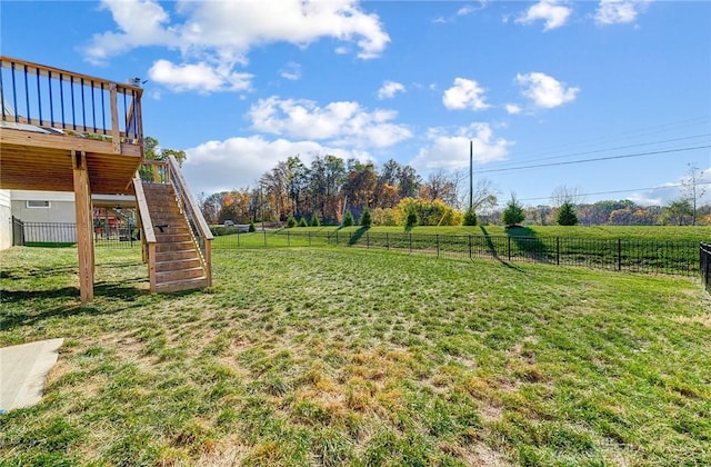 view of yard featuring a wooden deck, stairs, and a view of rural / pastoral area