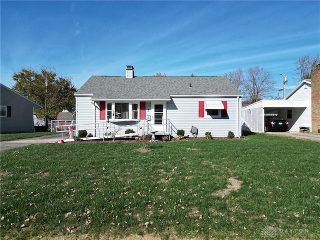 view of front of house featuring a front lawn, a carport, and covered porch