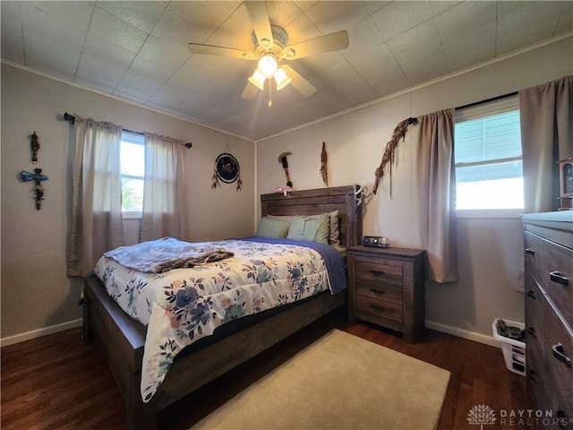 bedroom featuring ceiling fan, crown molding, and dark hardwood / wood-style flooring