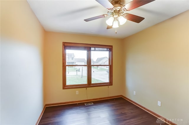 unfurnished room featuring ceiling fan and dark wood-type flooring