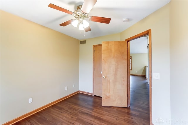 unfurnished bedroom featuring ceiling fan and dark hardwood / wood-style flooring