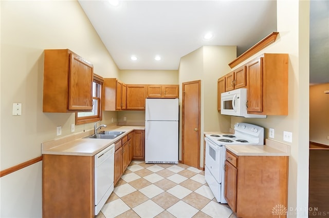 kitchen with vaulted ceiling, sink, and white appliances