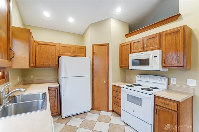 kitchen featuring white appliances and sink