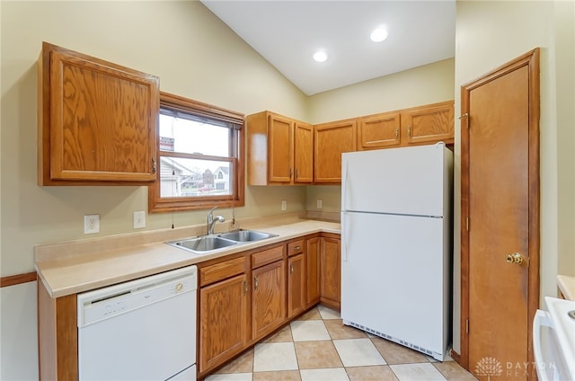 kitchen featuring white appliances, sink, and lofted ceiling