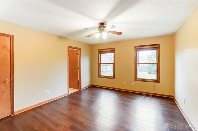 unfurnished room with ceiling fan and dark hardwood / wood-style floors