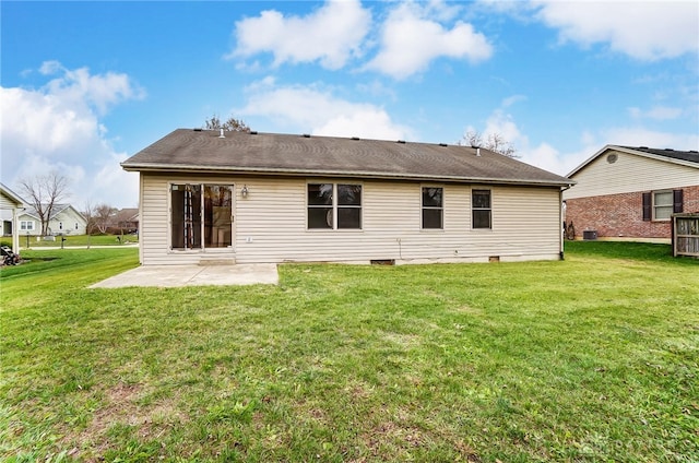 rear view of house featuring a patio and a lawn