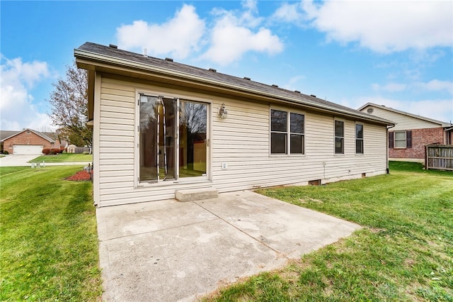 rear view of house with a lawn and a patio