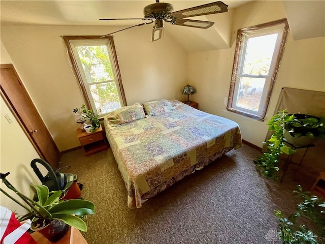 carpeted bedroom with ceiling fan and vaulted ceiling