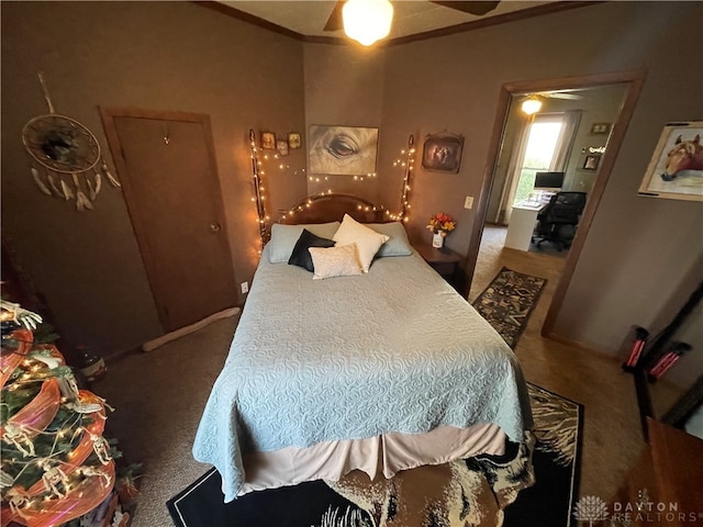 bedroom featuring carpet floors, ceiling fan, and crown molding