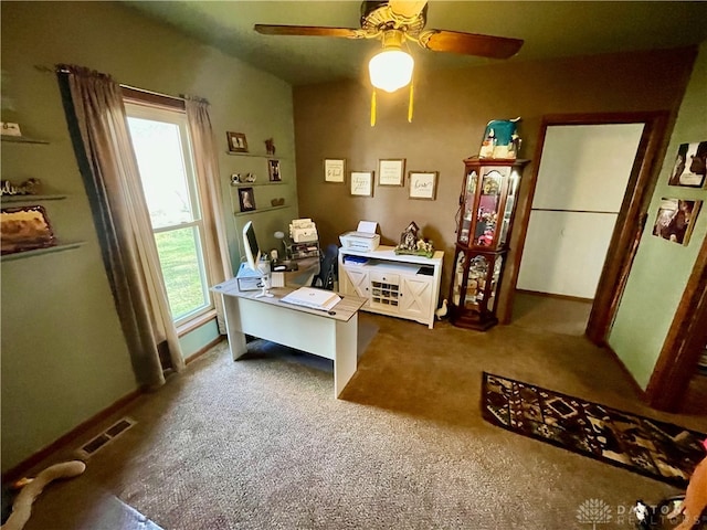 carpeted office space featuring ceiling fan