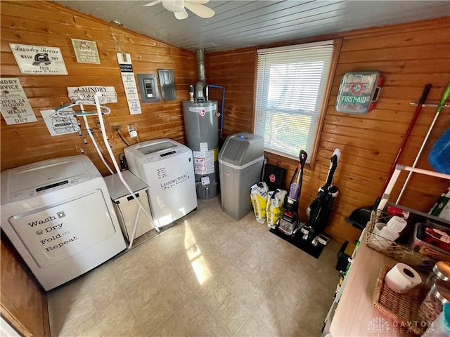 laundry room featuring wood walls, ceiling fan, separate washer and dryer, and water heater