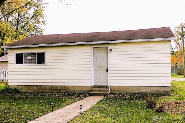 view of outbuilding with a lawn