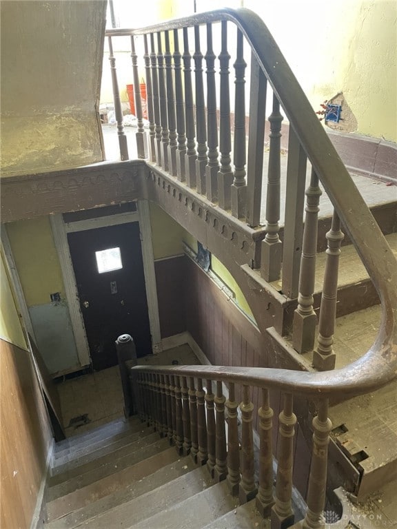 staircase with hardwood / wood-style floors