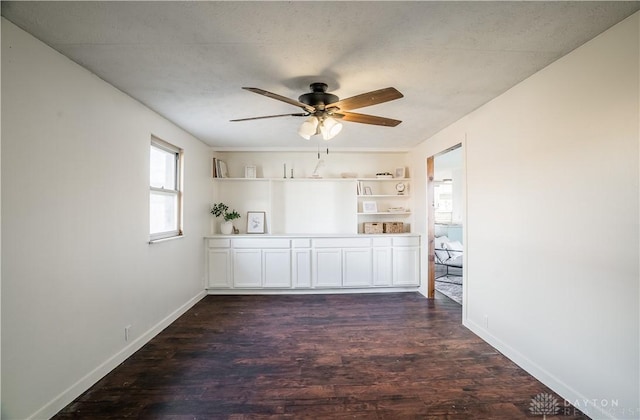 unfurnished room with dark wood-type flooring and ceiling fan