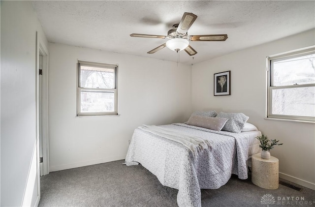 bedroom featuring ceiling fan, a textured ceiling, and carpet flooring