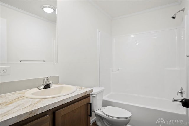 full bathroom with washtub / shower combination, vanity, toilet, and ornamental molding