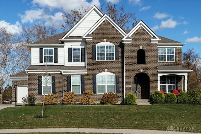 view of front of home featuring a garage and a front yard