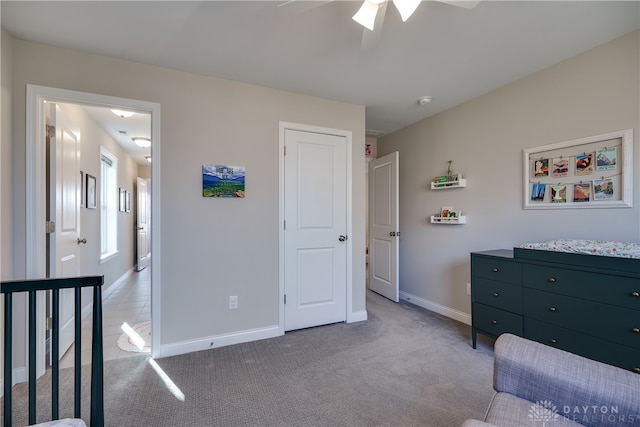 bedroom with light carpet and ceiling fan