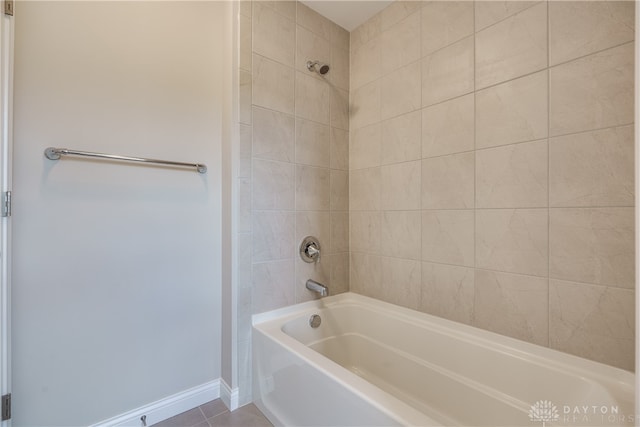 bathroom featuring tiled shower / bath and tile patterned floors