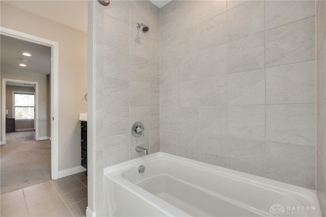 bathroom featuring tile patterned floors and tiled shower / bath