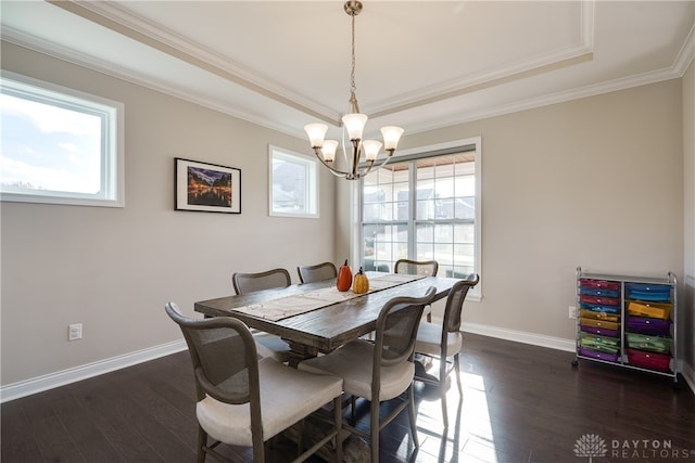 dining area with ornamental molding, dark hardwood / wood-style flooring, a healthy amount of sunlight, and an inviting chandelier