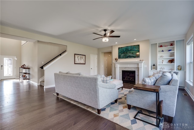 living room featuring dark hardwood / wood-style flooring and ceiling fan