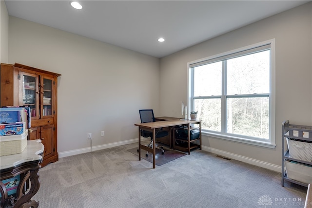 office area with light carpet and a healthy amount of sunlight