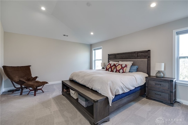 bedroom featuring light colored carpet, multiple windows, and lofted ceiling