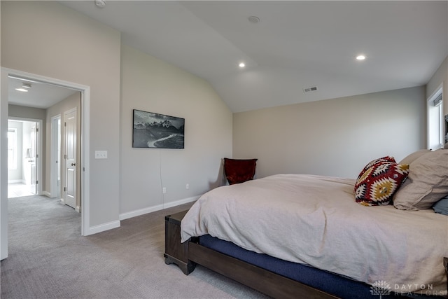 bedroom featuring lofted ceiling and light colored carpet