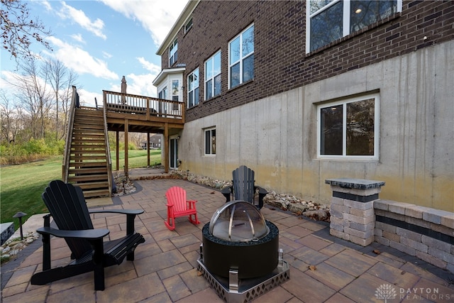 view of patio / terrace featuring a deck and an outdoor fire pit