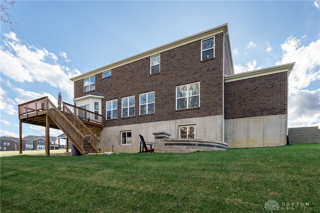 back of house with a wooden deck and a lawn