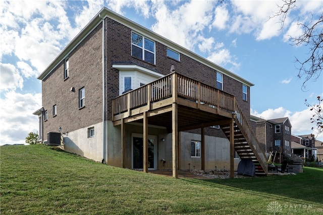 rear view of house featuring central air condition unit, a wooden deck, and a yard