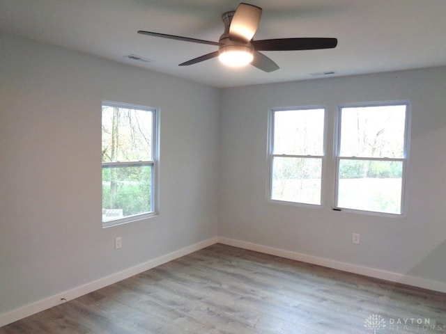 empty room with light hardwood / wood-style floors and ceiling fan