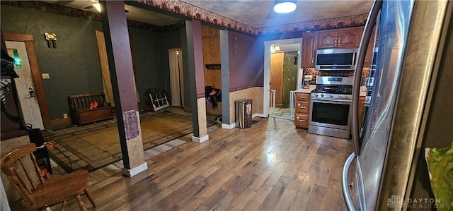 kitchen featuring wood-type flooring and appliances with stainless steel finishes