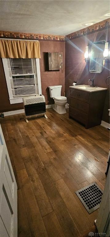 bathroom with vanity, wood-type flooring, and toilet